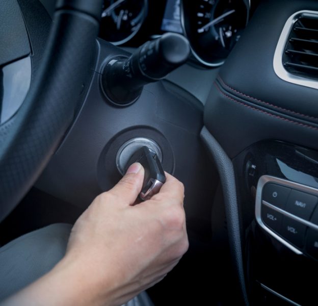 Hands Inserting Keys on Car